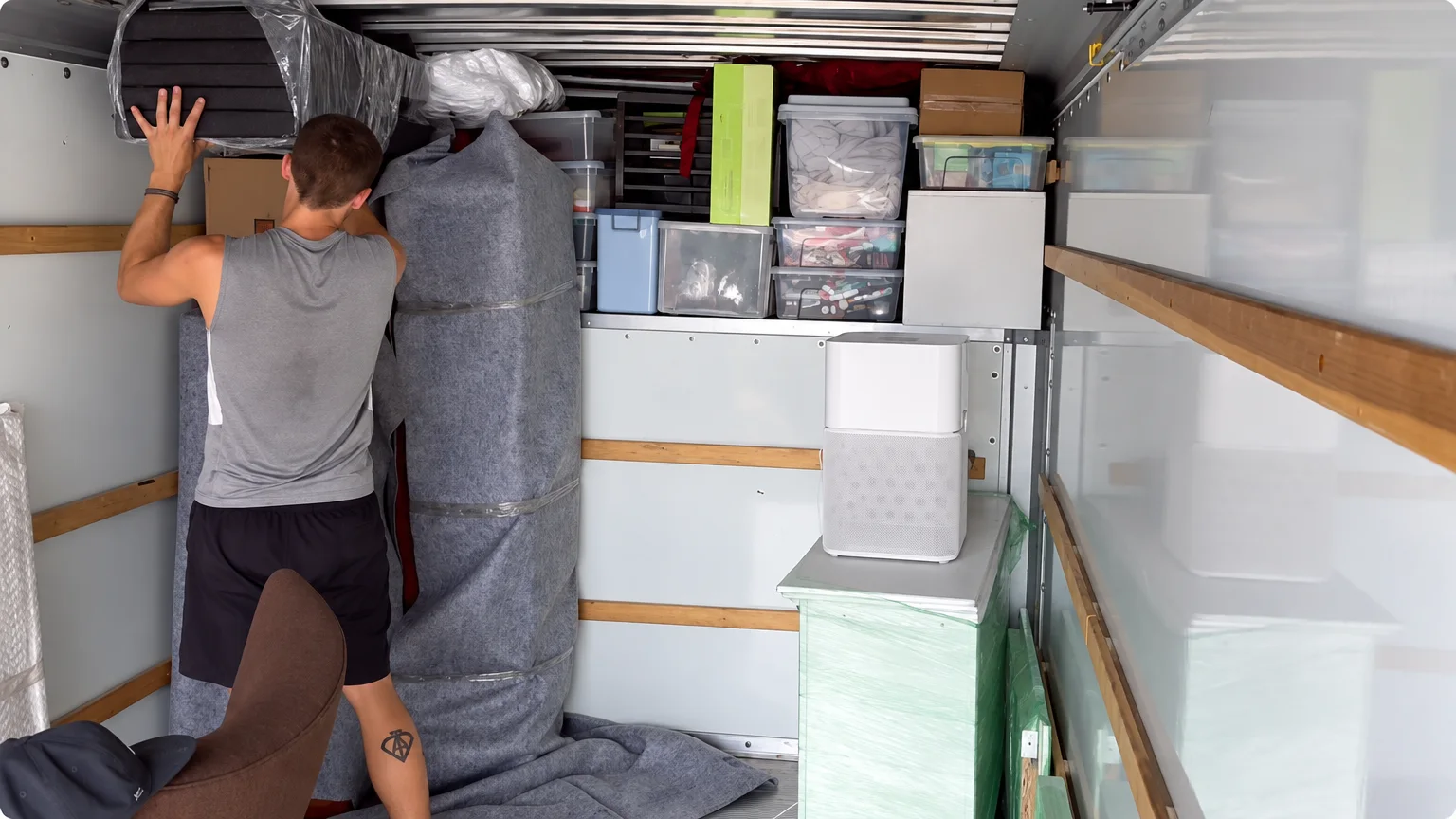 Movers preparing a large household item
